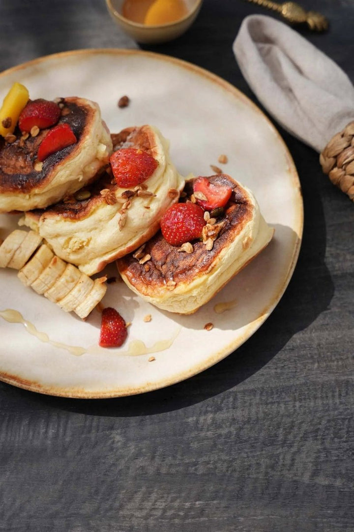 Baked goods with berries on a plate on a dark surface