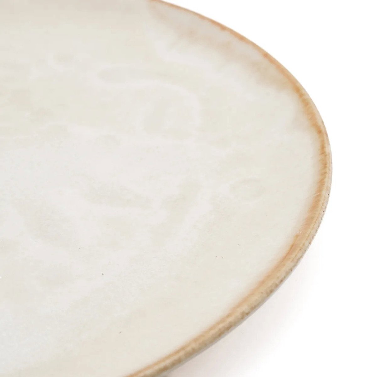 Close-up of a ceramic plate with a beige rim on a white background