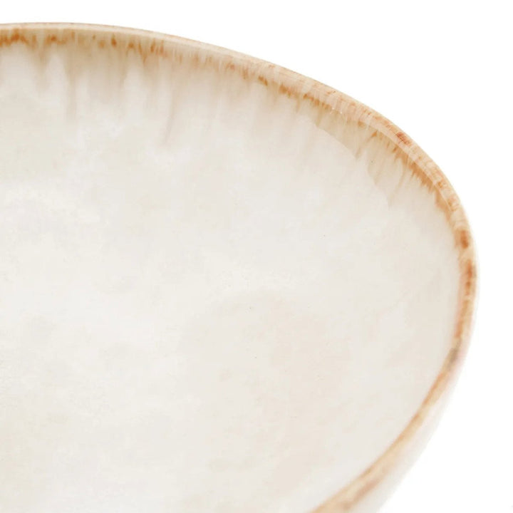 Close-up of a ceramic plate with a beige rim on a white background