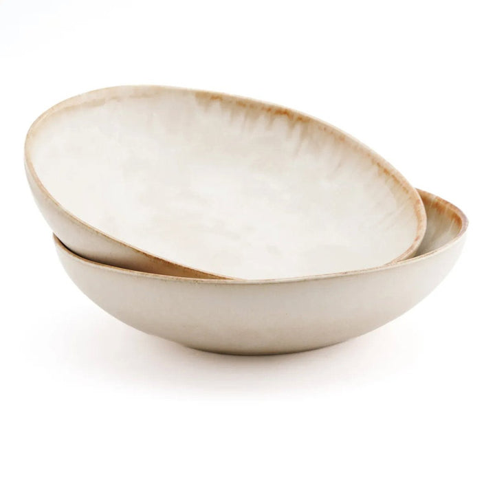 Two beige ceramic bowls stacked on a white background