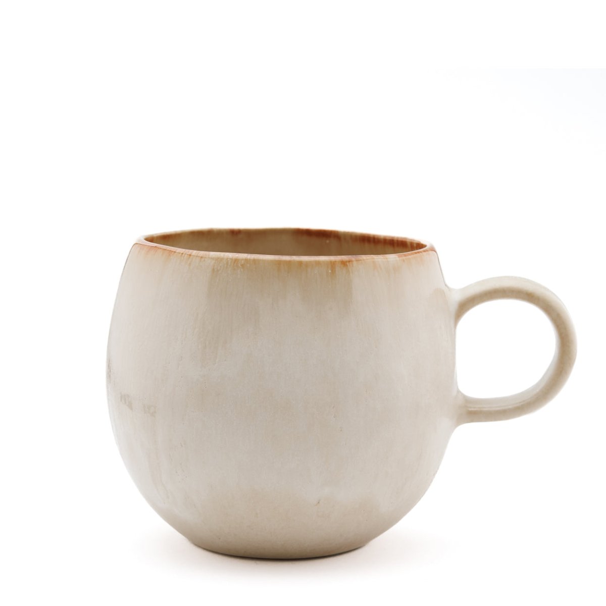 Beige ceramic mug with brown rim on a white background