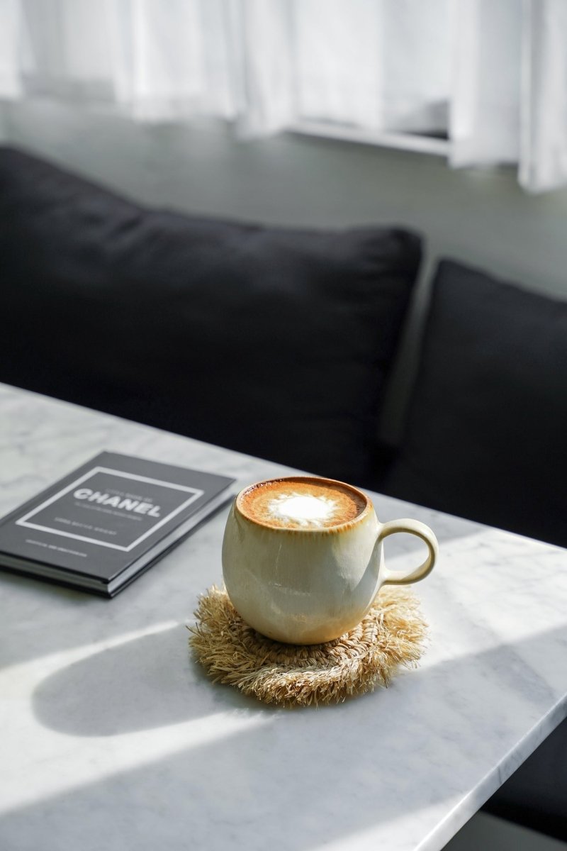 Cup of coffee on a marble table with a blurred background