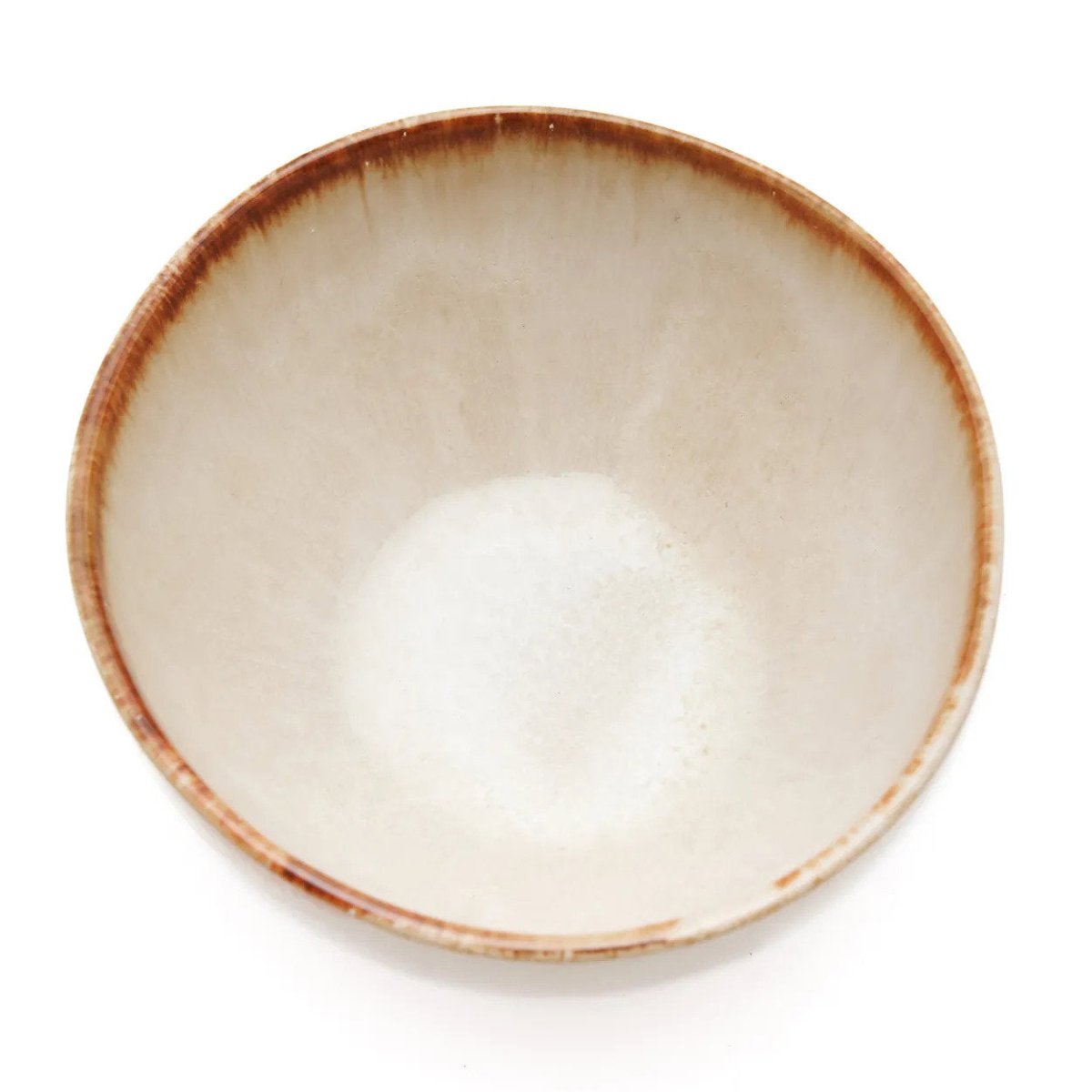 Beige ceramic bowl with brown rim on a white background