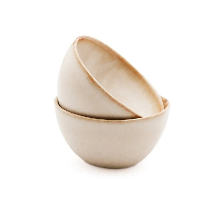 Two beige ceramic bowls stacked on a white background