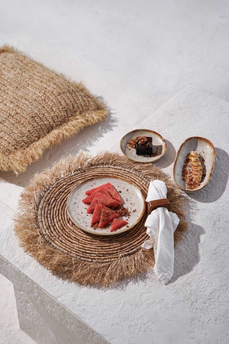 Plated food on a textured surface with a woven placemat