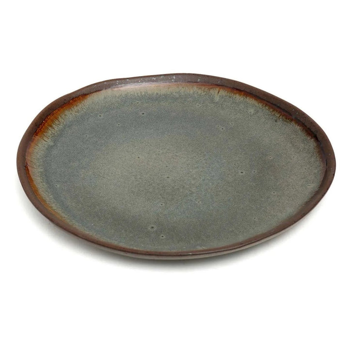 Ceramic plate with a brown rim on a white background