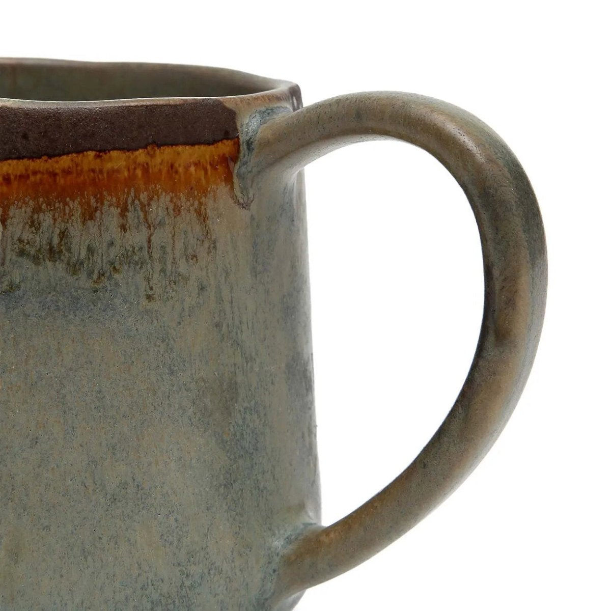 Close-up of a ceramic mug with a handle on a white background