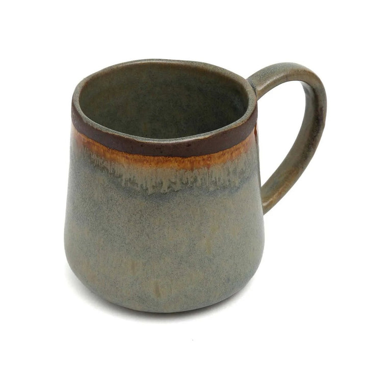 Ceramic mug with a brown rim and handle on a white background