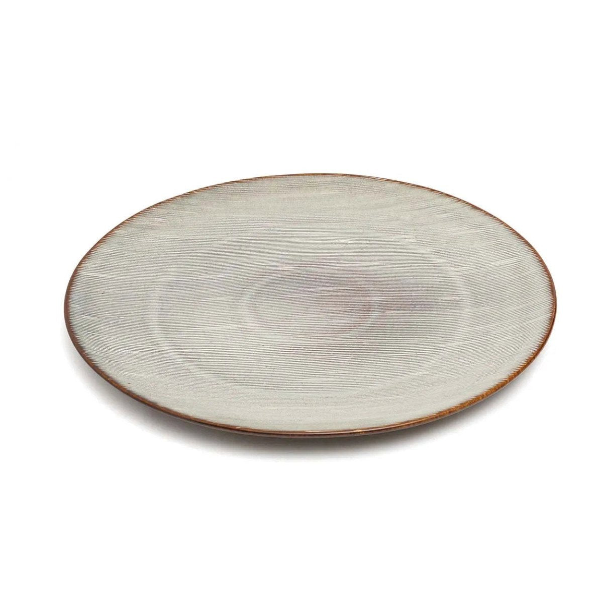 Round ceramic plate with a textured surface on a white background