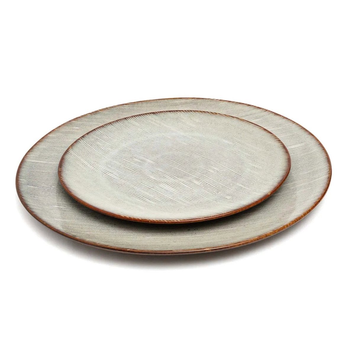 Two ceramic plates with a textured surface on a white background