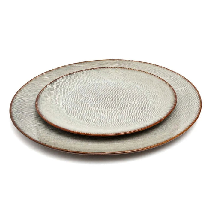 Two ceramic plates with a textured surface on a white background