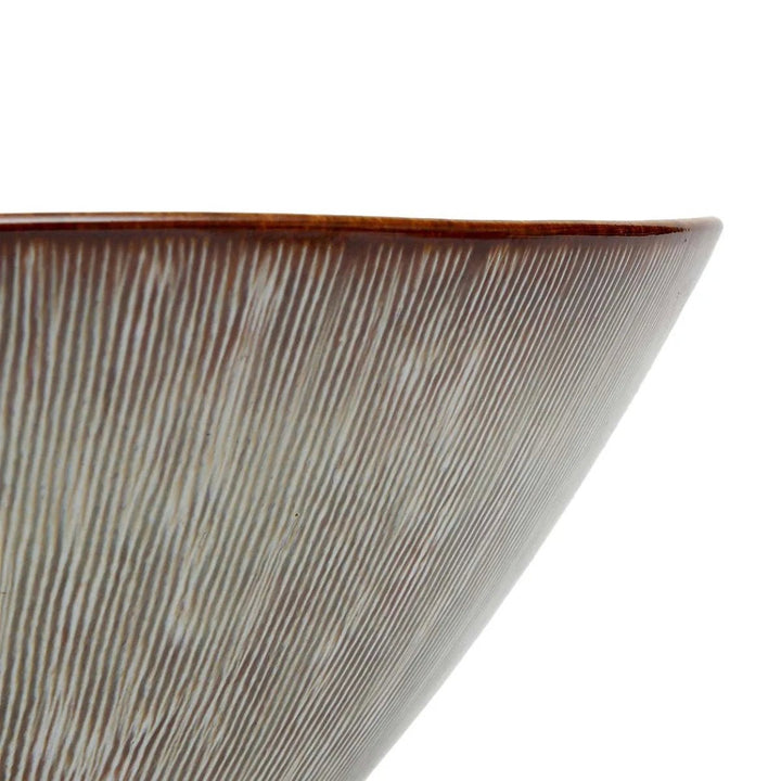 Close-up of a ceramic bowl with textured surface on a white background