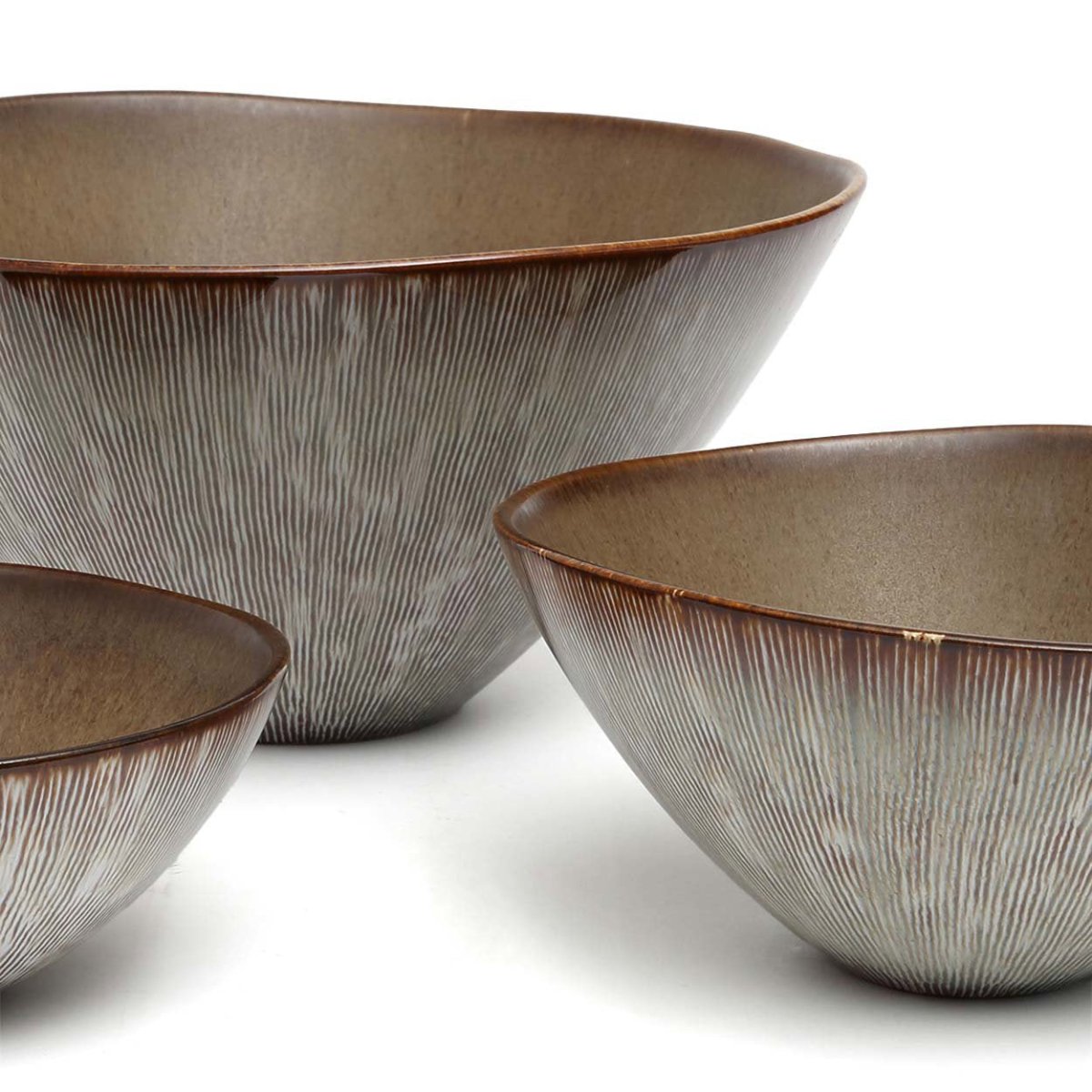 Three ceramic bowls with textured surface on a white background