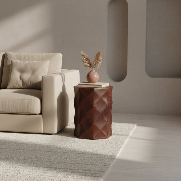 Beige armchair with a textured brown side table in a minimalistic room.