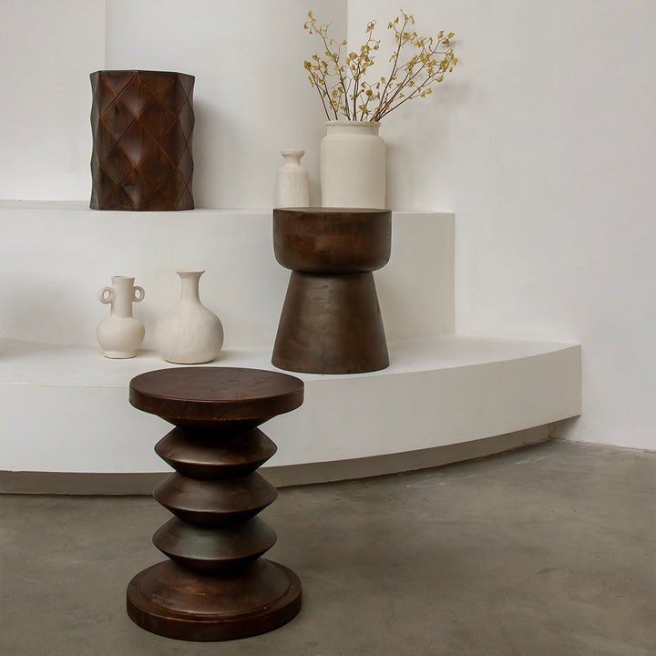 Wooden stools and vases on a white platform with a neutral background