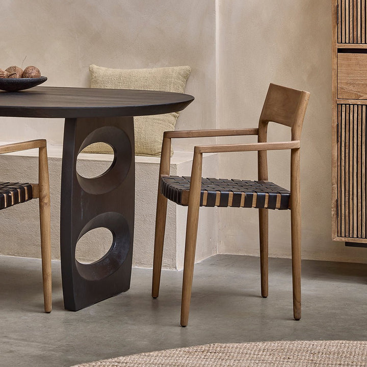 Dining table with wooden chairs in a modern interior setting
