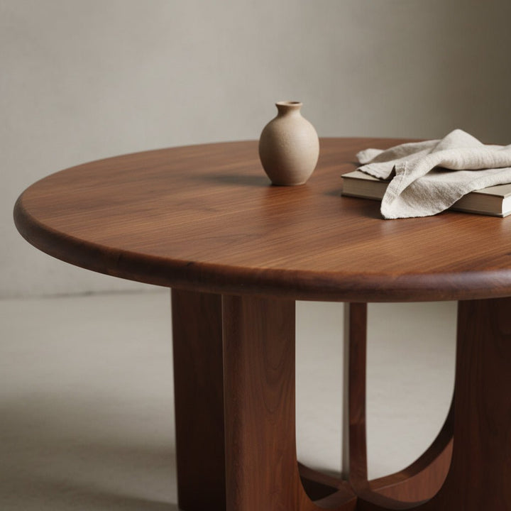 Wooden table with a vase and books on a neutral background