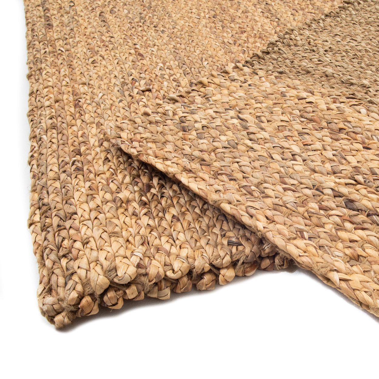 Close-up of a woven natural fiber rug on a white background