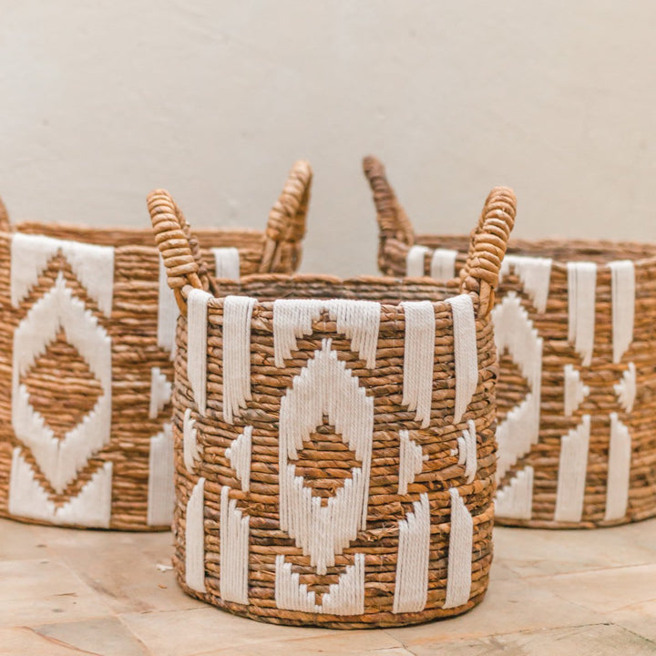 Woven baskets with geometric patterns on a wooden surface