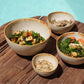 Set of Cascais Bowls in yellow and white ceramic, styled on rustic table by poolside.