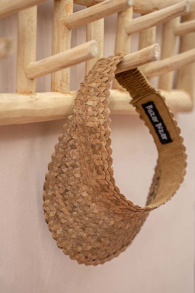 Island Coat Rack in natural teakwood with hanging crocheted item, decorative and practical for indoor use.