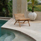 Handcrafted teak wood chair next to a pool, Islander Eenzit - Natural design.