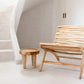 Handcrafted teak wood chair, Islander Eenzit - Natural, with unique organic design in a minimalist setting.