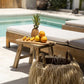 Quincy Stool made from natural reclaimed teak by a poolside setting.