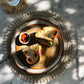 Seagrass Shell Placemat with cowrie shell border under a sandwich and dip.