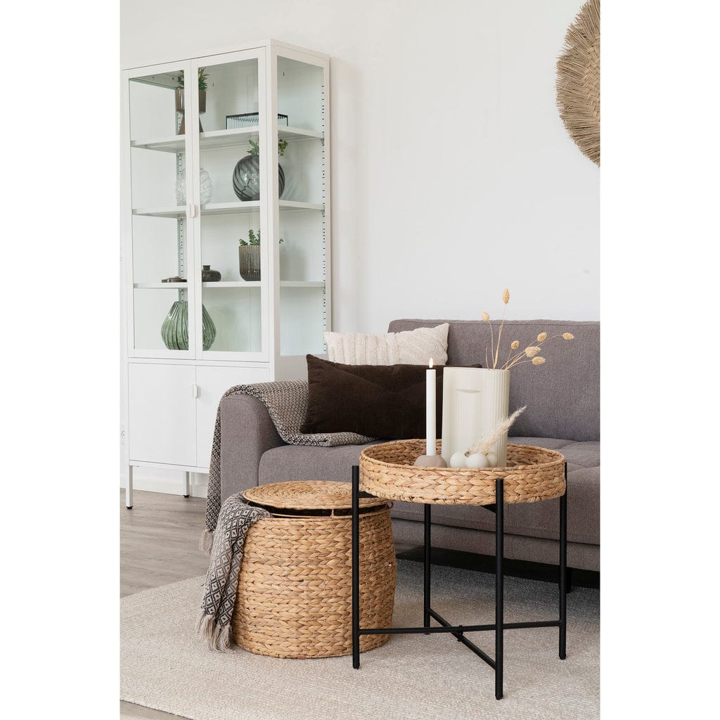 Delia Side Table – Round Water Hyacinth Table with Storage in living room setting.