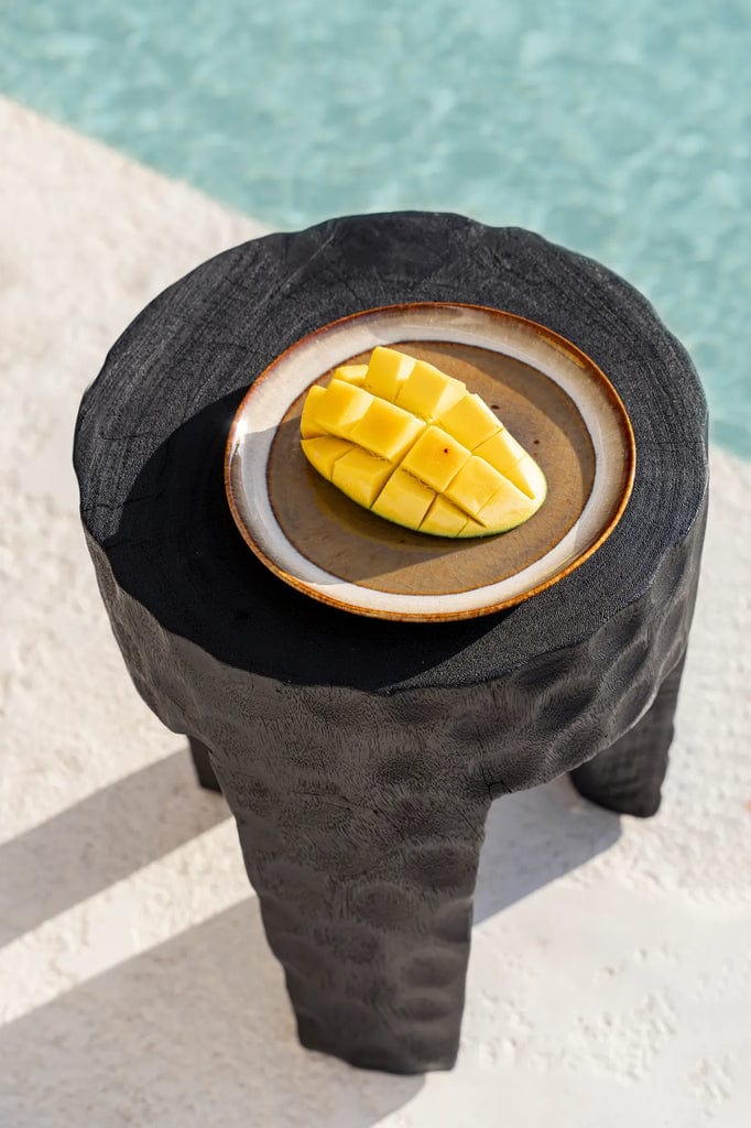 Comporta Dessert Plate with sliced mango on textured black table near pool.