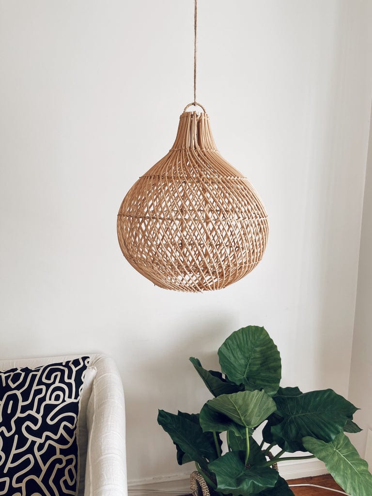 Mandala Round Rattan Lampshade with natural cross design hanging in a boho-inspired room.