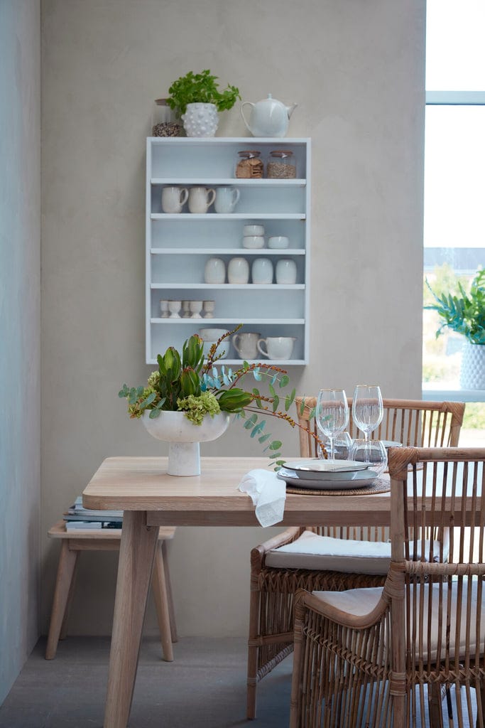 Norah Handwoven Rattan Dining Chair in a natural dining setting.