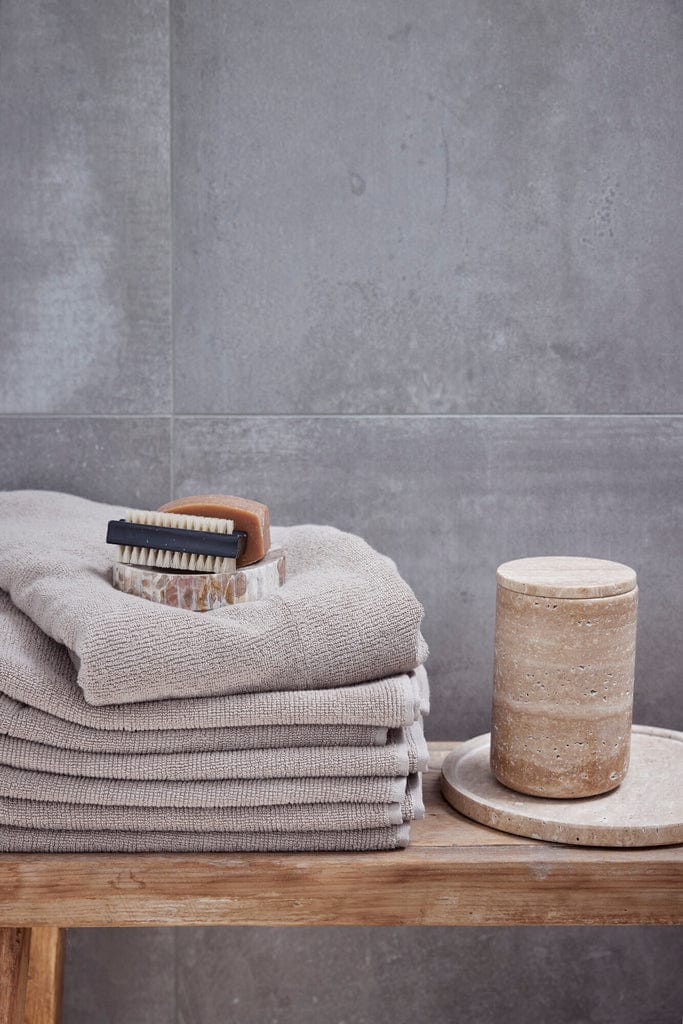 Travina Linen Jar on wooden shelf against grey background.