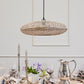 Novie Bamboo Pendant Lamp hanging over a dining table, showcasing its natural round design and soft glow.