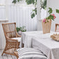 Olivia Tablecloth 220x140 cm sand striped on a dining table with outdoor decor.