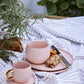Olivia Tablecloth 220x140 cm in sand striped pattern with pink cups on a table setting.