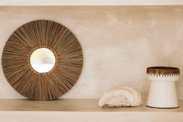 Pretty Candle Holder - White Natural terracotta with raffia accent on a stylish shelf.